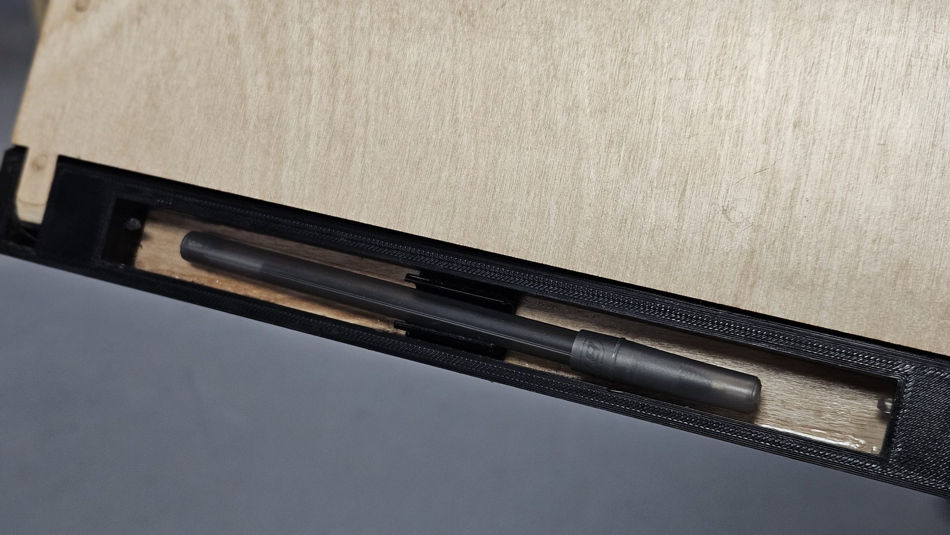 Pen resting in the built-in pen storage channel in the frame