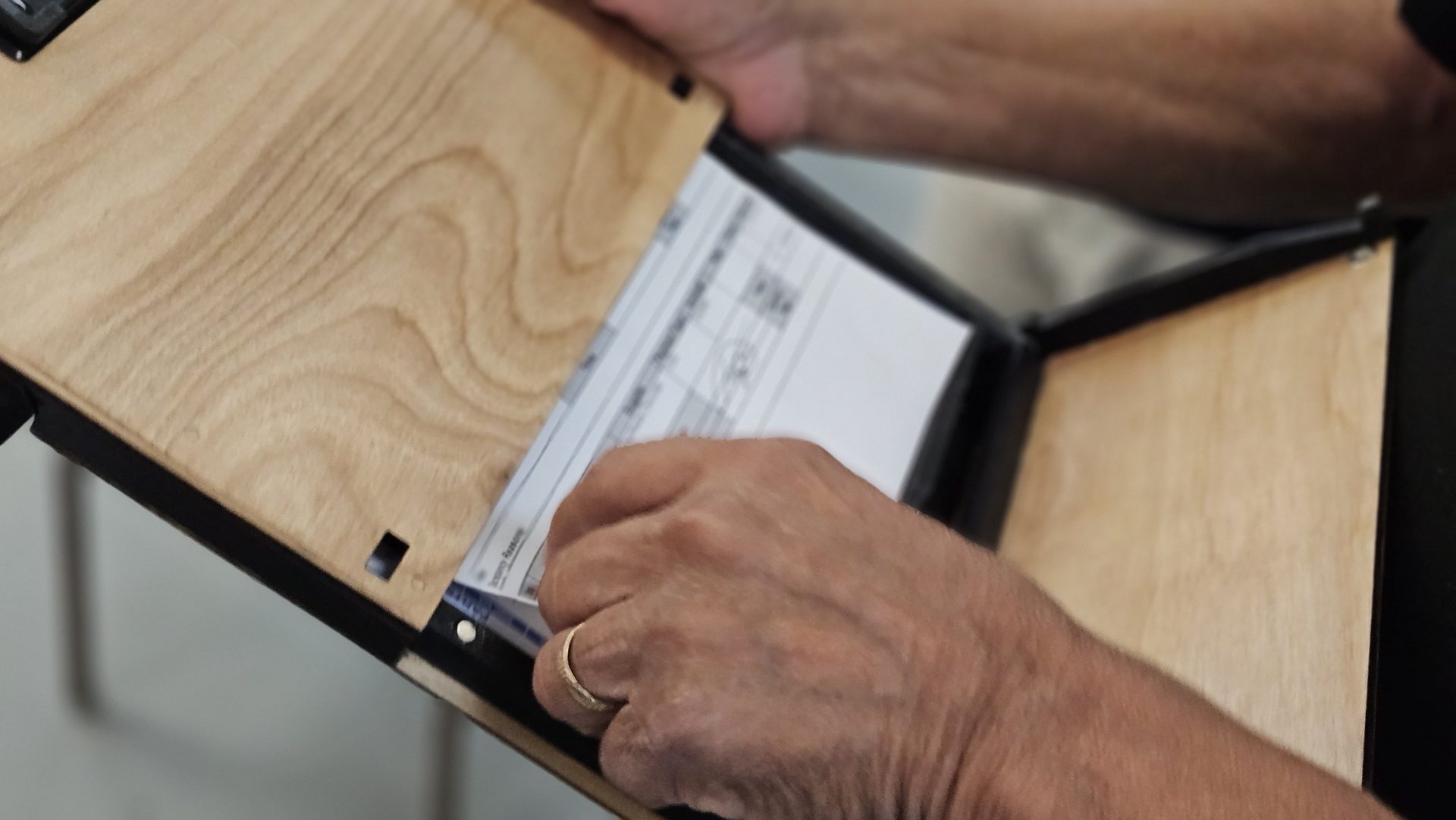 Hand pulling paperwork out of the DeskDrive Pro internal storage